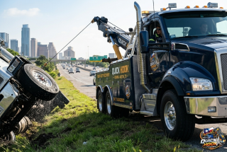 Heavy duty wrecker recovering overturned truck